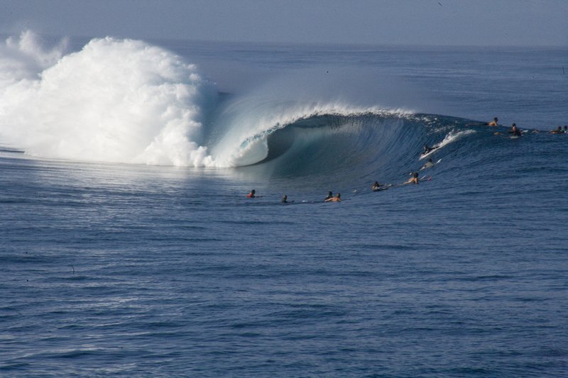 Surfer riding a wave at Teahupo'o, Tahiti