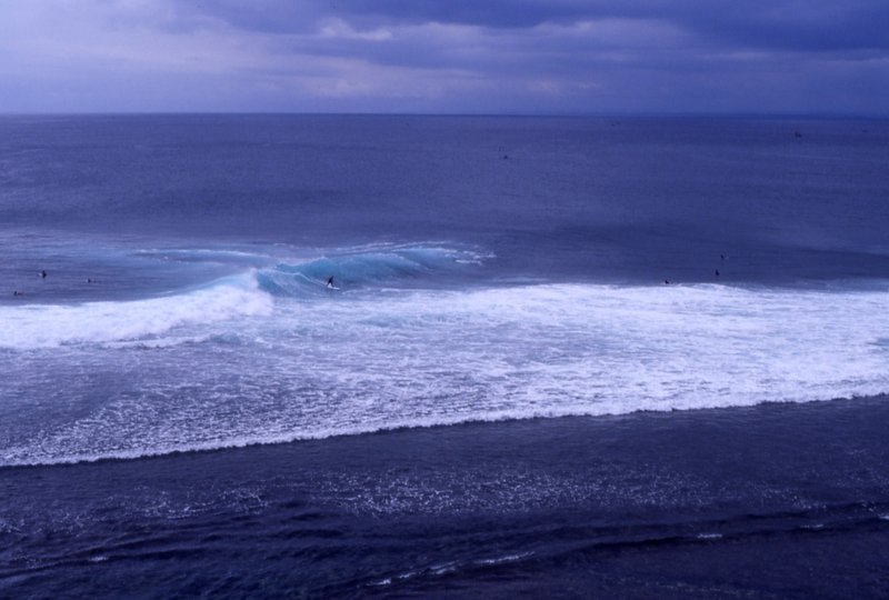 Surf breaking below the cliffs at Uluwatu, Bali