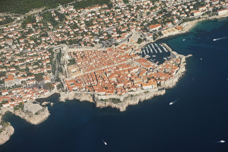 Aerial view of Dubrovnik's old town, red rooftops, and the Adriatic Sea