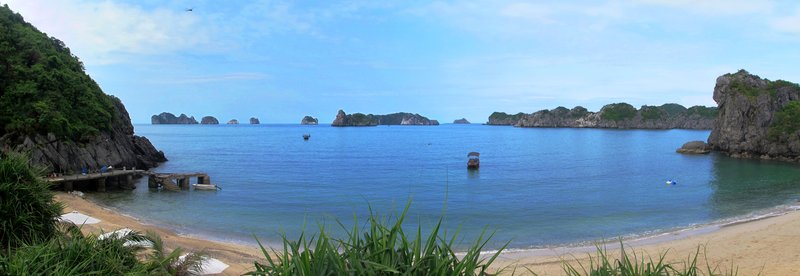 Limestone karst islands rising from the calm waters of Ha Long Bay