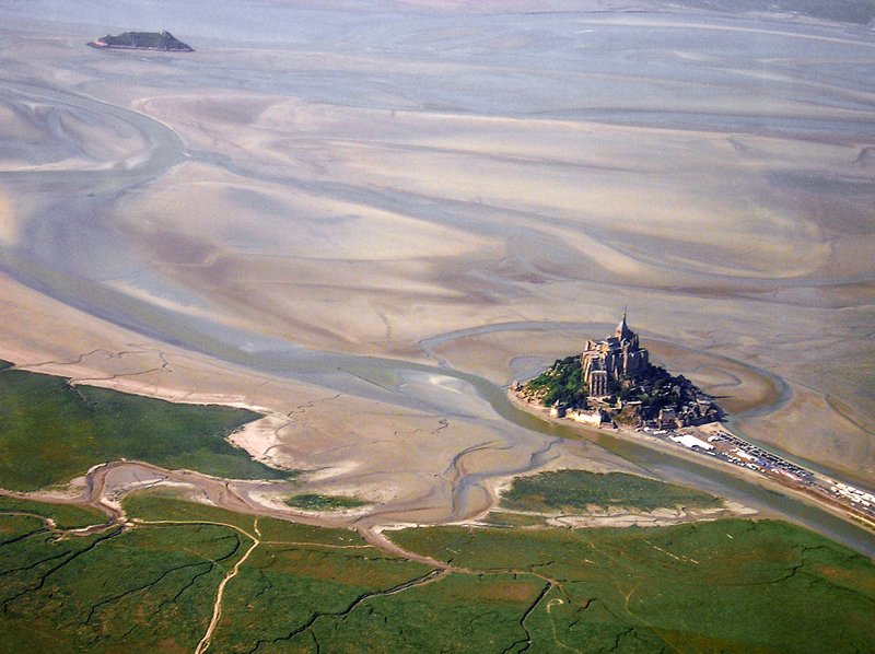 Aerial view of Mont-Saint-Michel abbey rising from its tidal bay