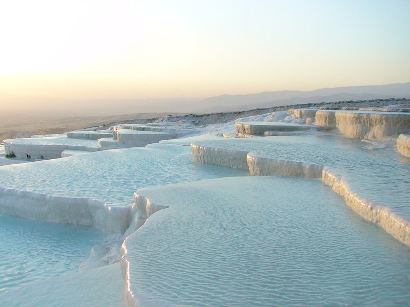 Pamukkale's white travertine terraces and thermal pools cascading down the hillside