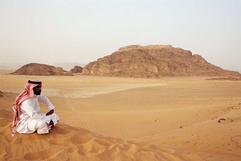 Dramatic sandstone rock formations rising from the Wadi Rum desert
