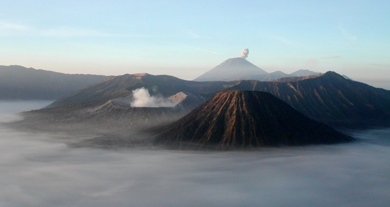 Mount Bromo and Mount Semeru rising through morning mist in Java