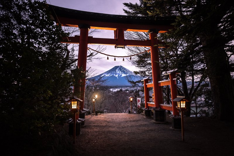 Mount Fuji's iconic snow-capped cone above the Japanese countryside