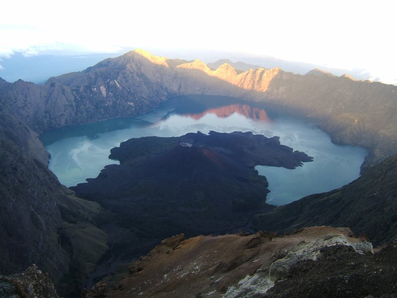 Mount Rinjani's volcanic cone above Lombok's forested slopes