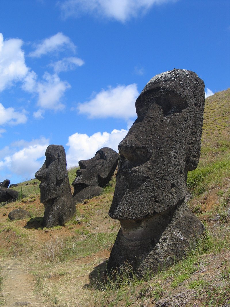 Row of moai statues carved from volcanic tuff on the slopes of Rano Raraku, Easter Island
