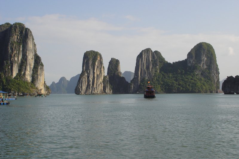 Limestone karst islands rising from the emerald waters of Ha Long Bay, Vietnam
