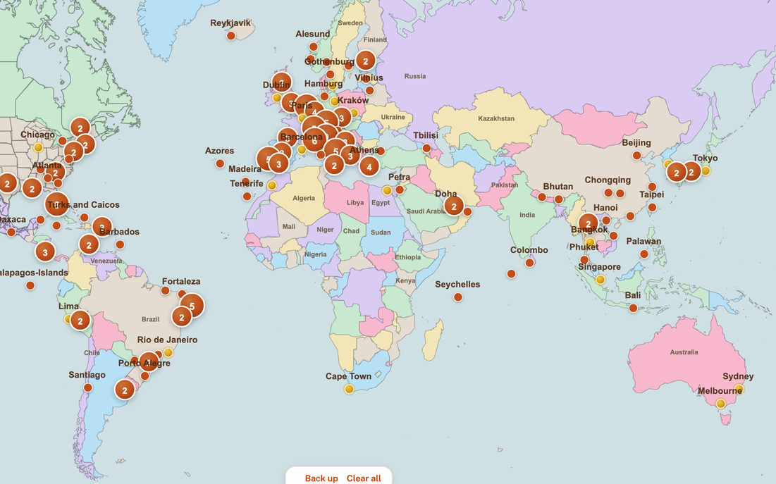 The world map over Europe, terracotta pins for the destinations still ahead and gold ones for the cities already marked