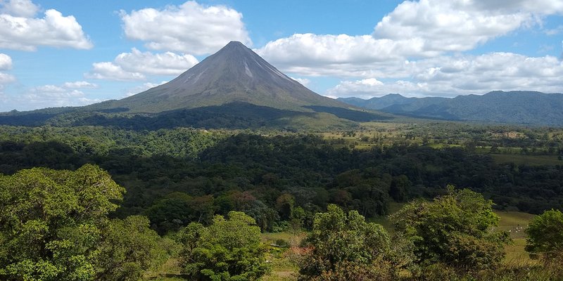 Arenal Volcano cone rising above the national park lava fields