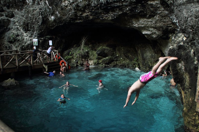 Vivid turquoise cenote lagoon at Hoyo Azul inside Cap Cana